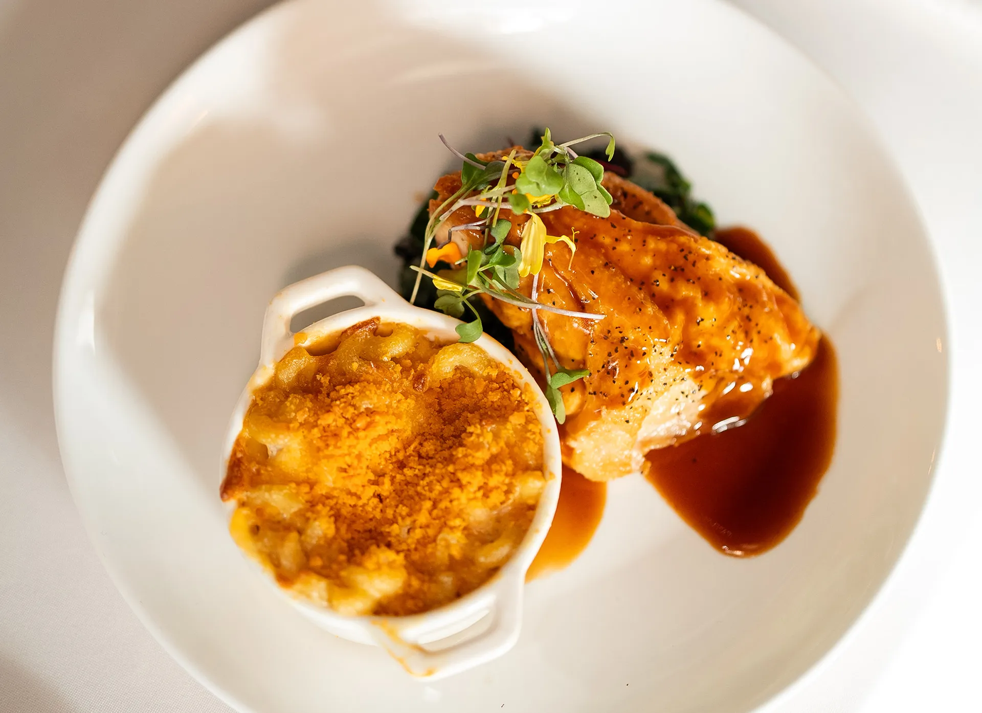 Seared salmon with microgreens and a side of baked mac and cheese
