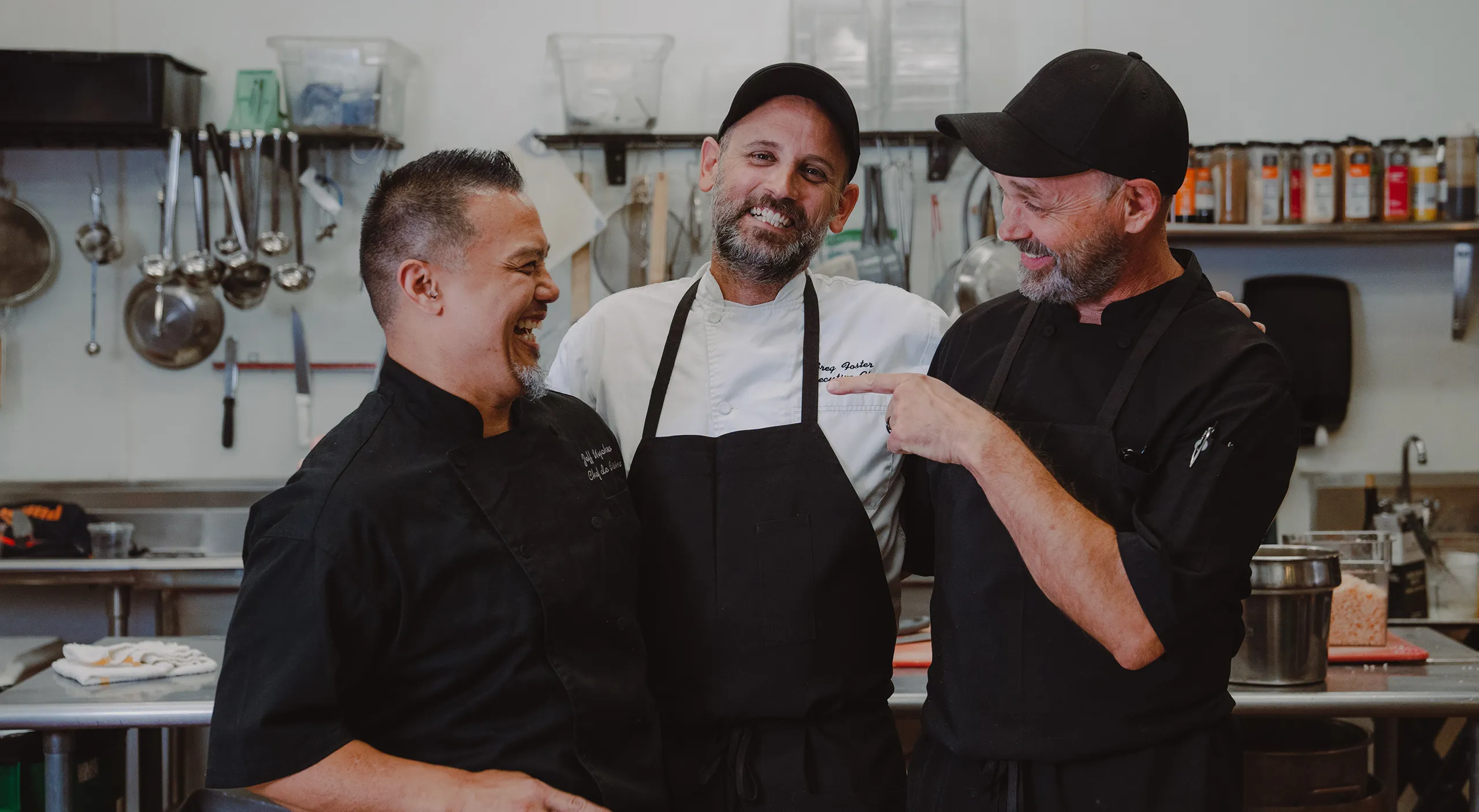 Three Beets chefs sharing a laugh in the kitchen