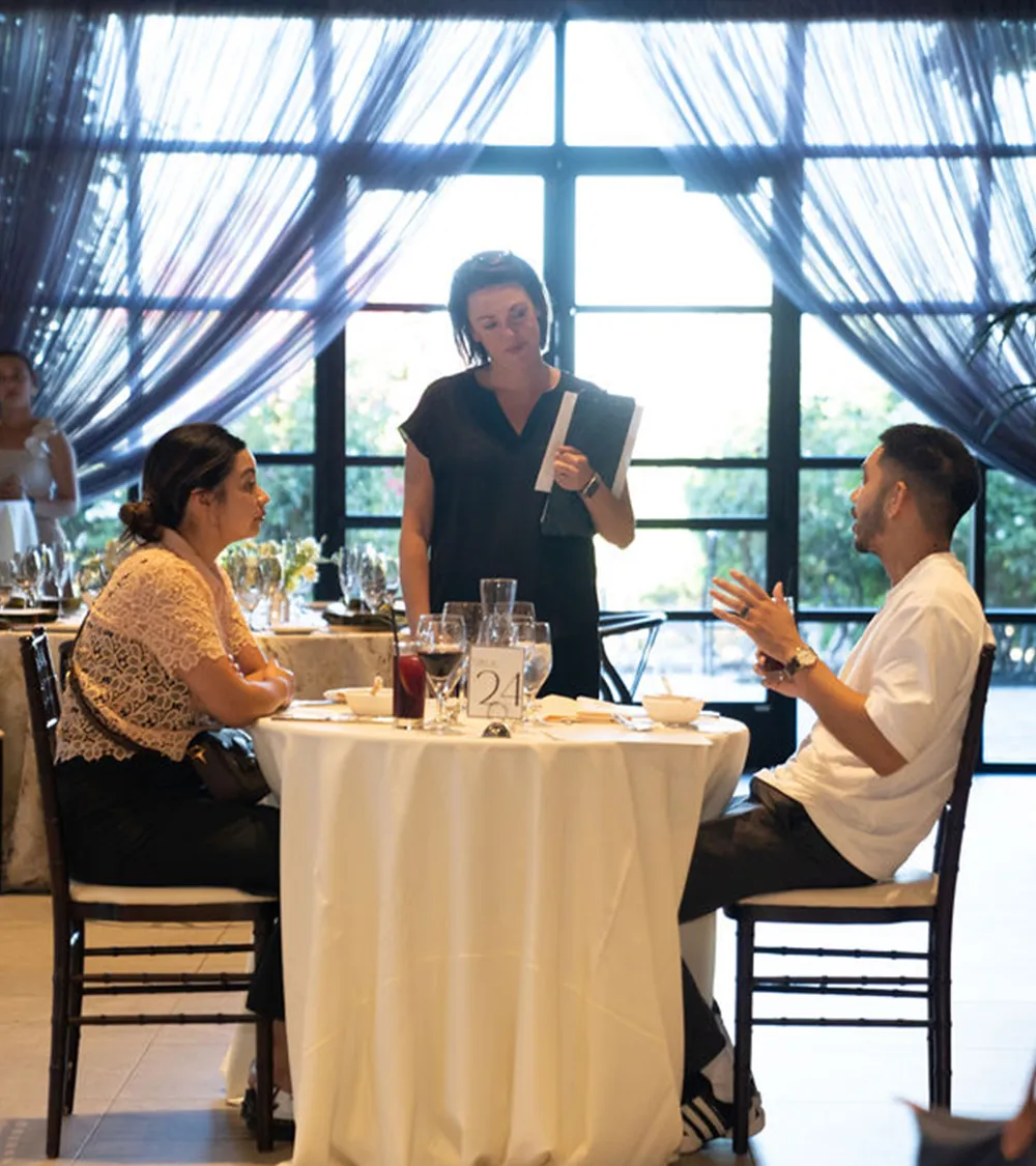 Couple being presented menu options by their event coordinator in an airy venue