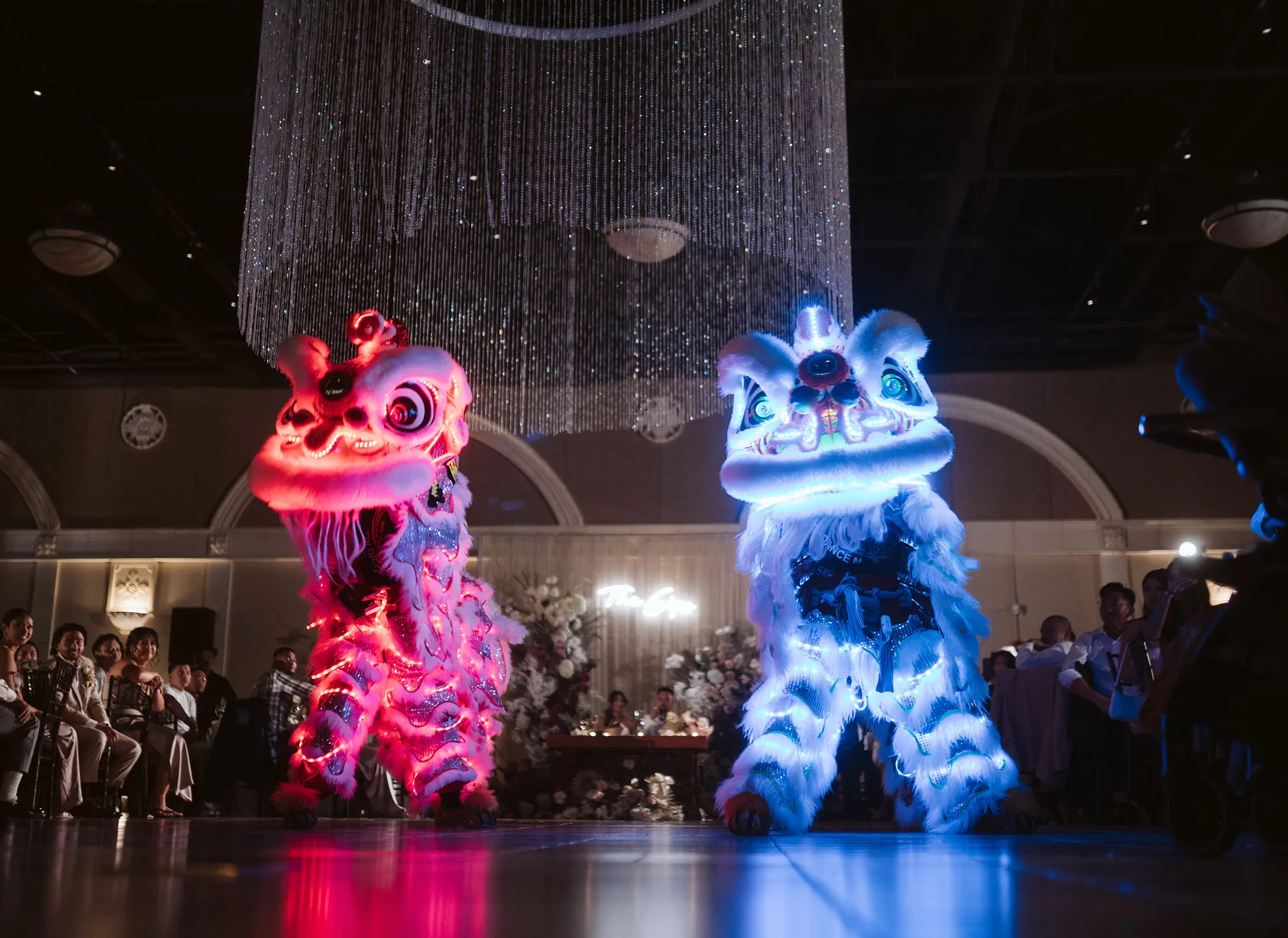 LED-lit lion dance performance at a wedding reception